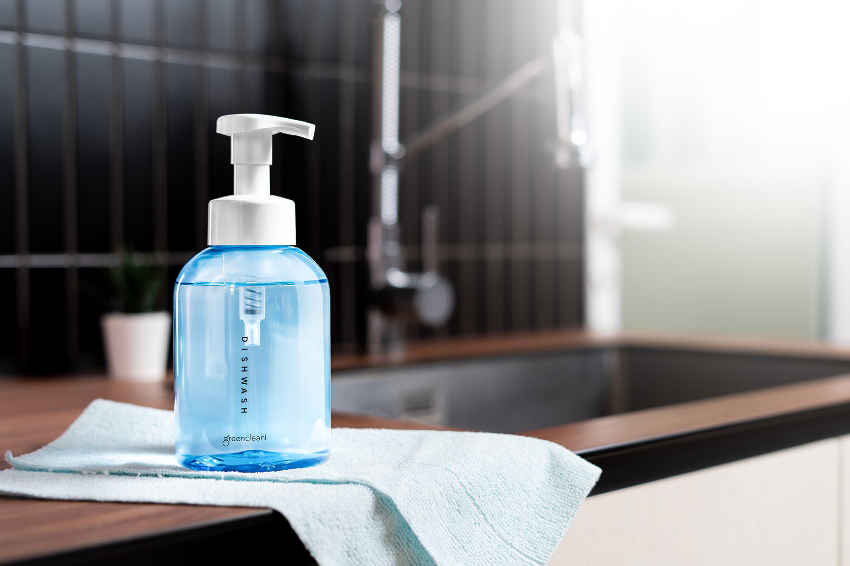Keep your Malaysian kitchen sparkling and safe with Greencleani's non-toxic dishwash liquid, shown in its stylish blue reusable dispenser bottle